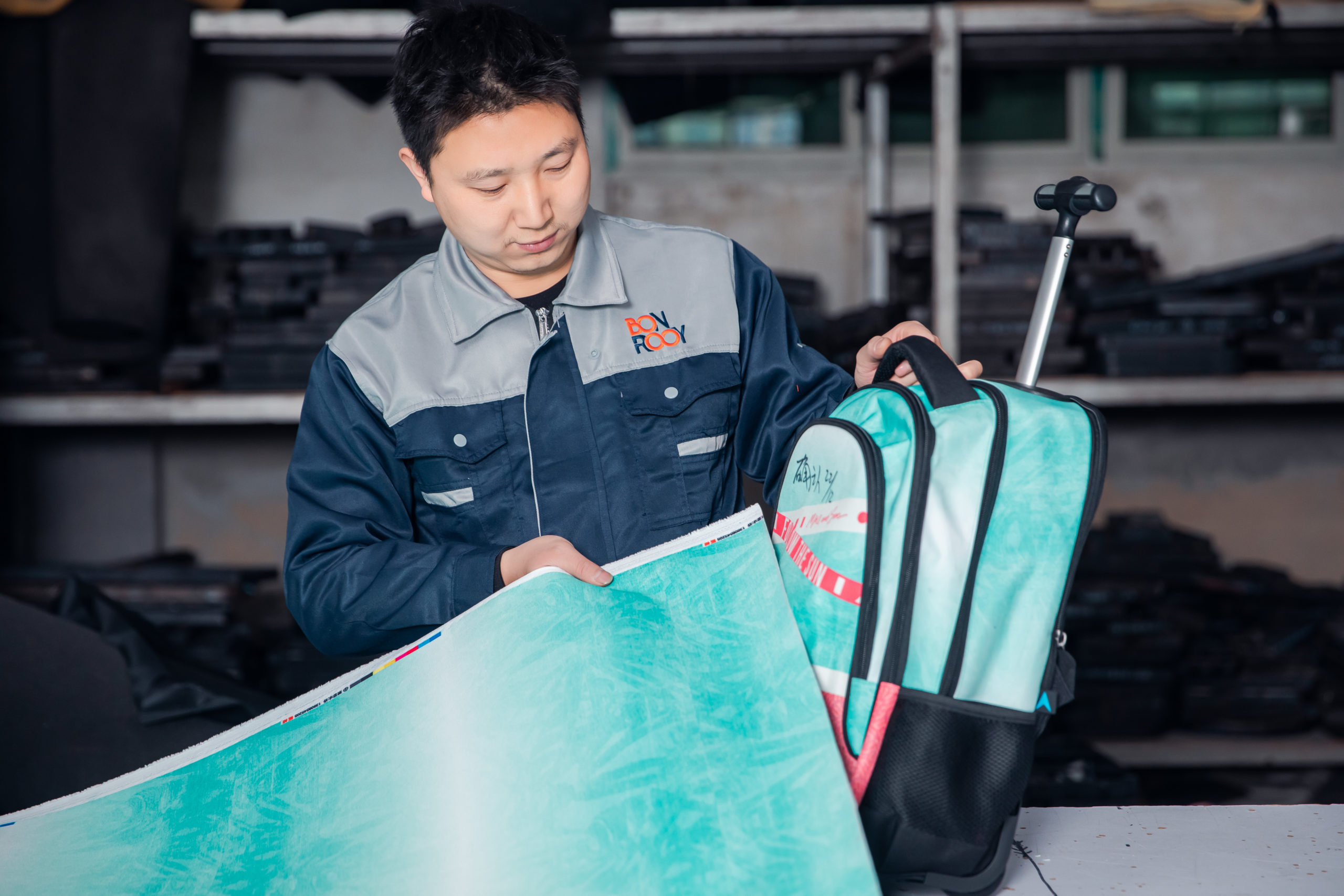 A worker is strictly comparing the different color blocks of materials and samples.